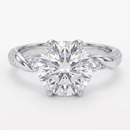 Close-up of Tresor Diamond's The Grace Ring with sparkling gemstones and intricate band design on a white background.